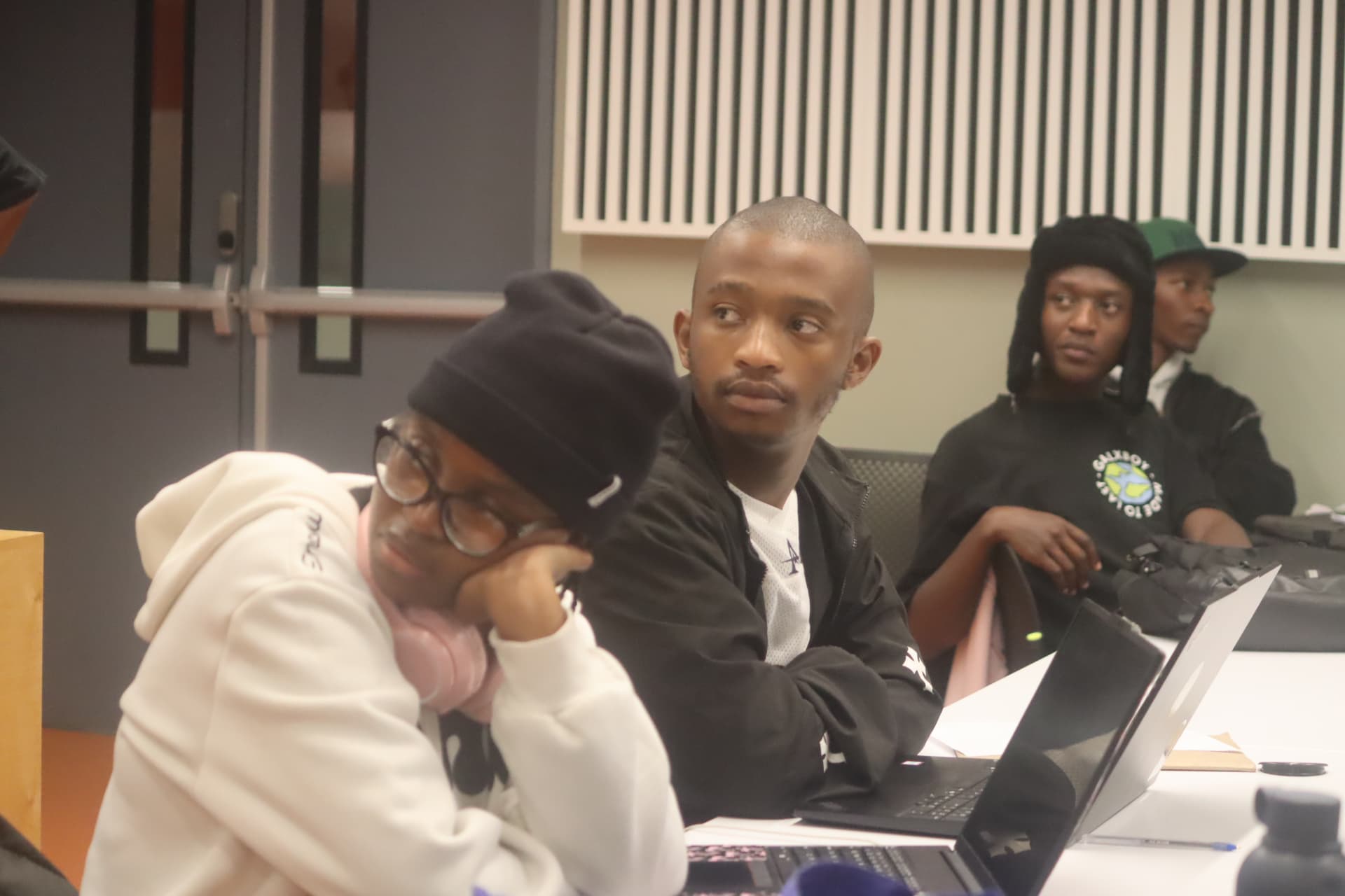 Participants gathered around laptops during the Northern Cape hackathon