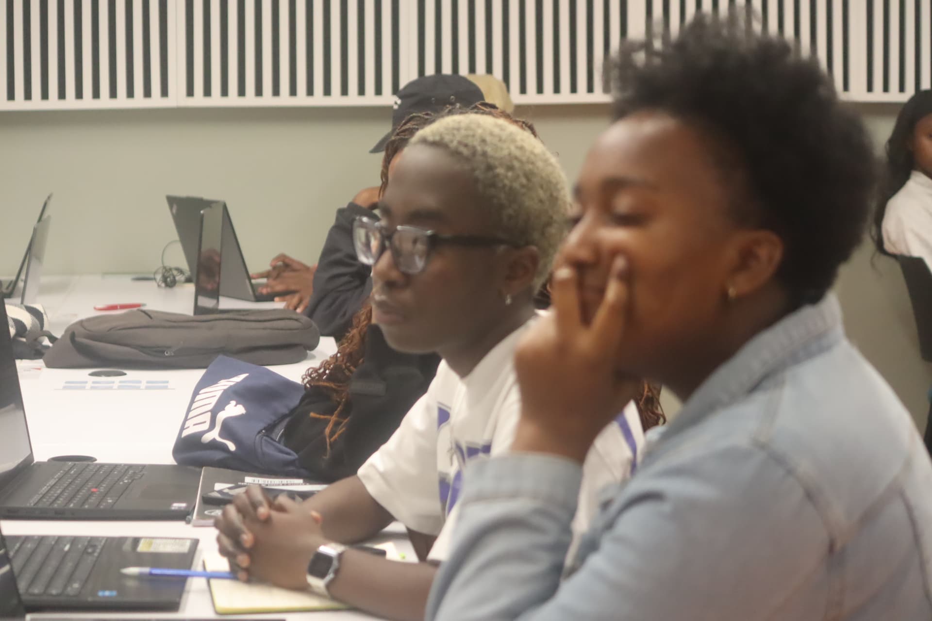 Participants working at laptops during a hackathon bootcamp session