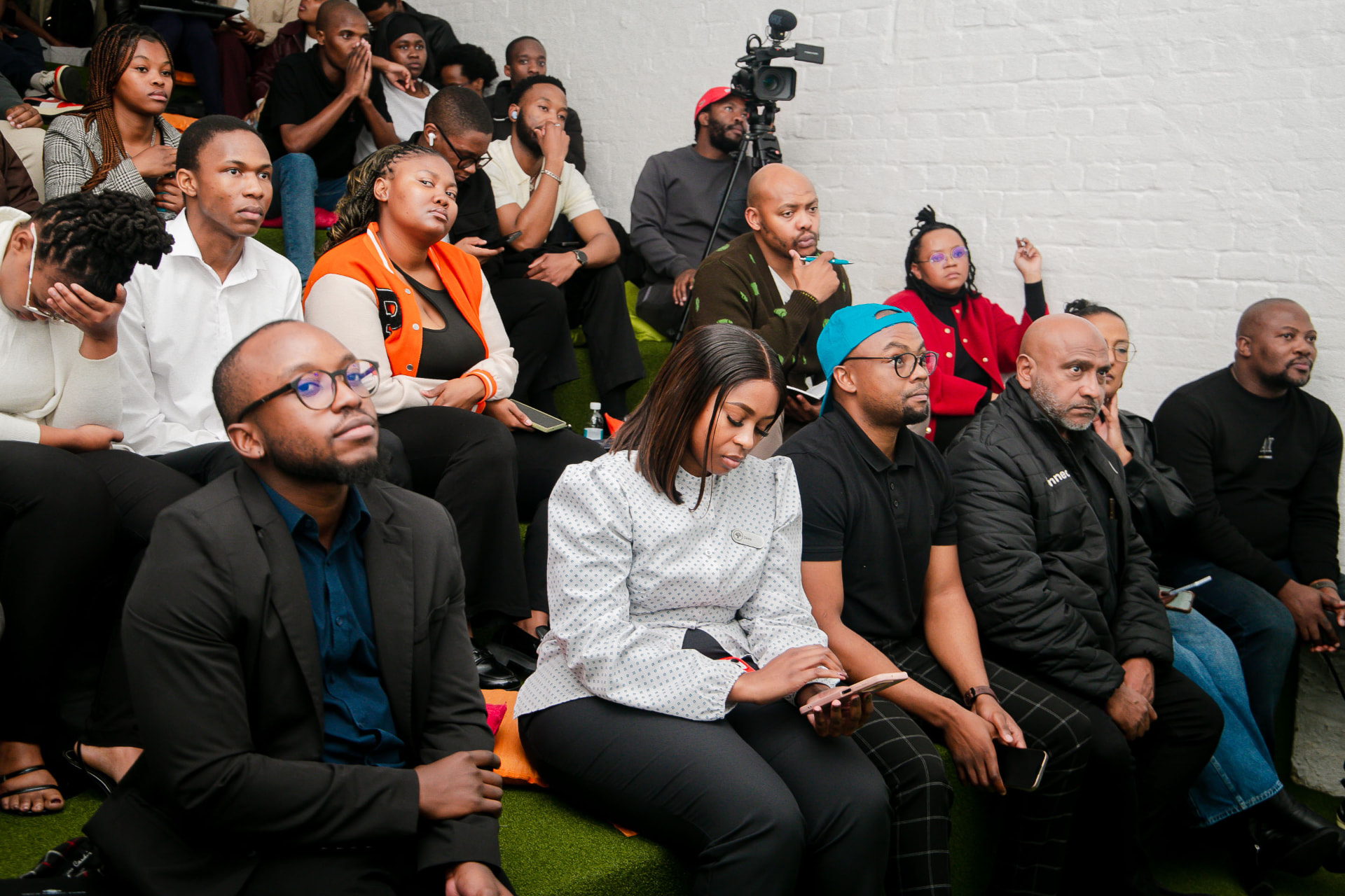 Founders, mentors and judges watching presentations at a Cortex Accelerator Hub session